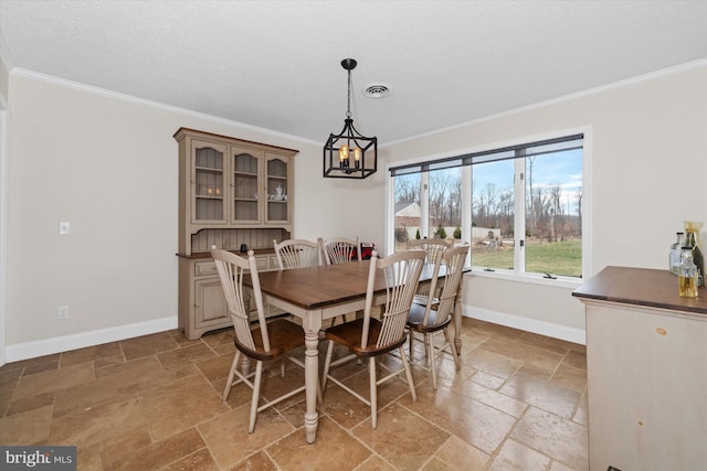 dining area featuring baseboards, visible vents, an inviting chandelier, ornamental molding, and stone tile flooring