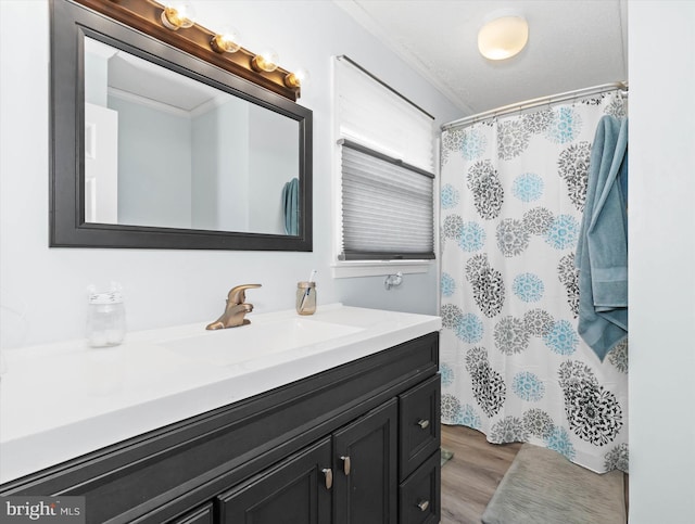 bathroom featuring vanity, crown molding, a shower with curtain, and wood finished floors