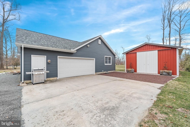 garage featuring concrete driveway