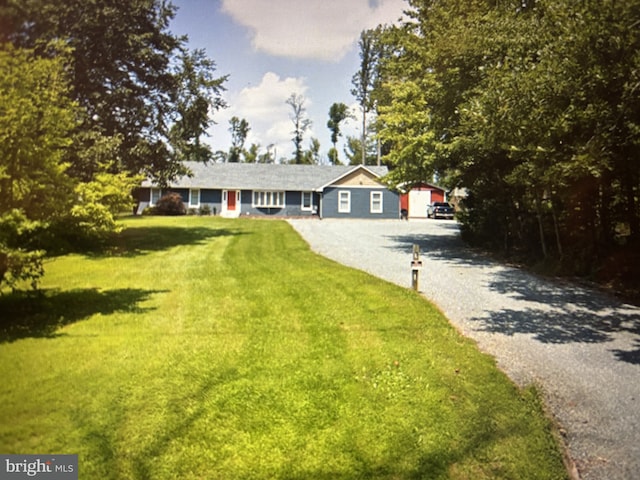 single story home with a front lawn and driveway