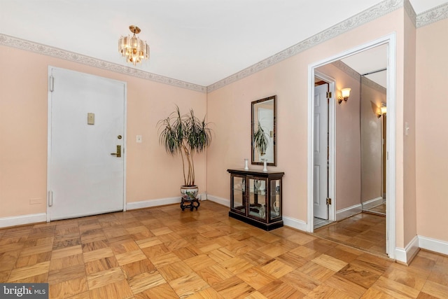 foyer entrance with baseboards and an inviting chandelier