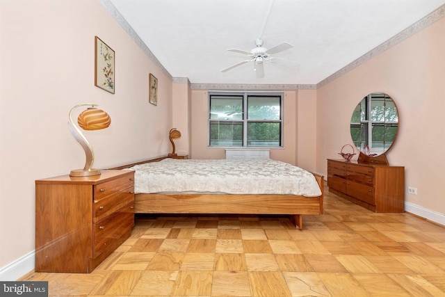 bedroom featuring crown molding and baseboards