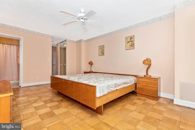 bedroom with a ceiling fan and baseboards