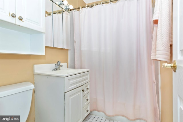 bathroom featuring toilet, vanity, and a shower with shower curtain