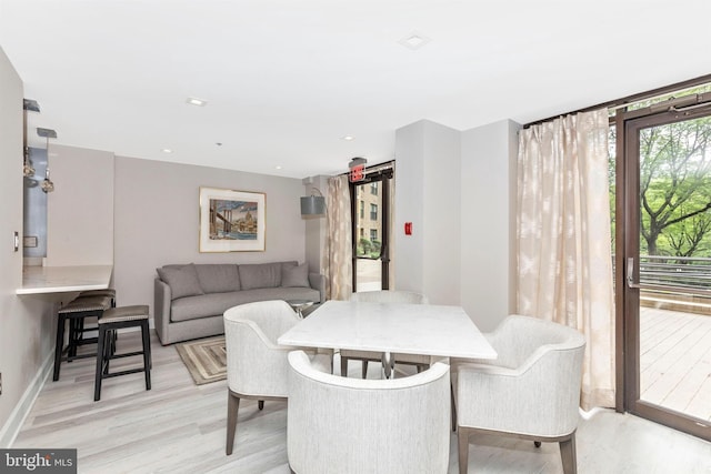 dining room featuring recessed lighting, light wood-type flooring, and baseboards