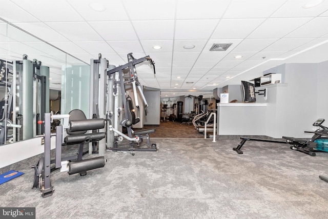 exercise room with carpet flooring, recessed lighting, visible vents, and a drop ceiling