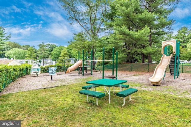 communal playground with fence and a lawn