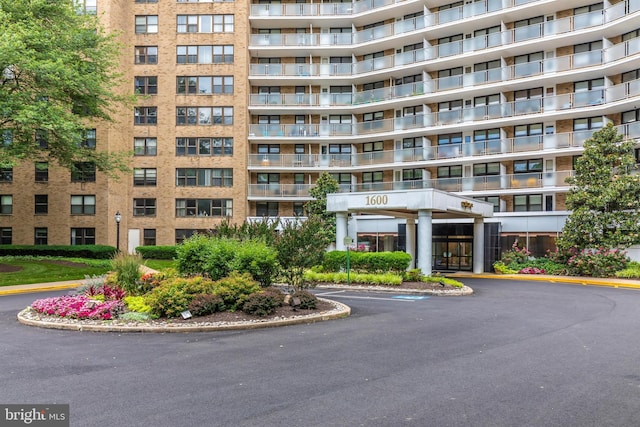 view of building exterior featuring uncovered parking