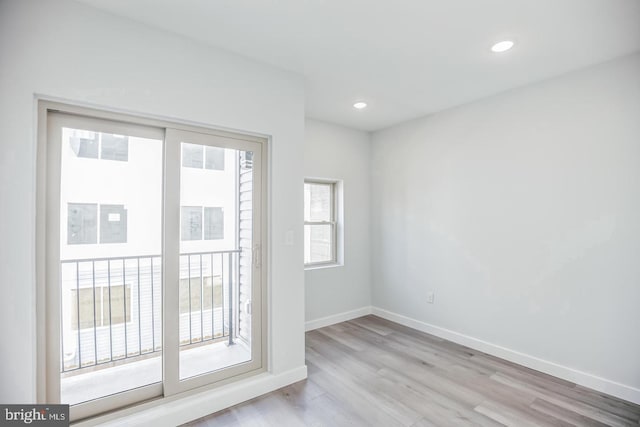 empty room featuring recessed lighting, baseboards, and wood finished floors