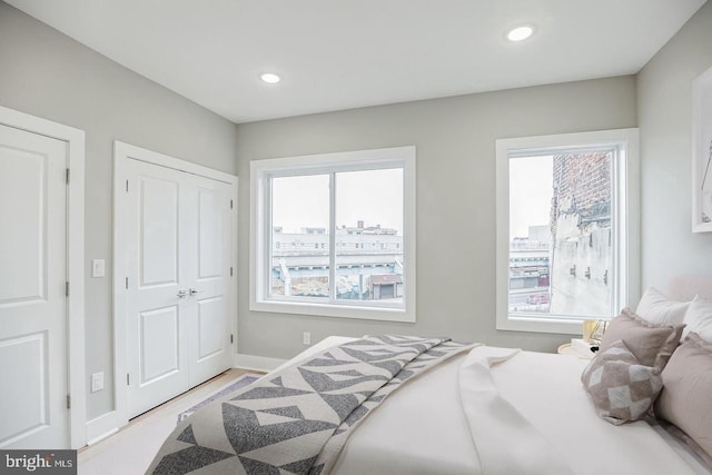 bedroom featuring multiple windows, recessed lighting, and baseboards