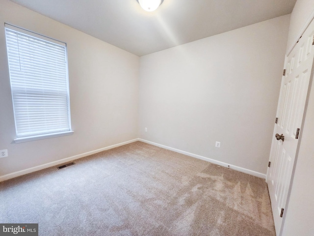 unfurnished bedroom featuring visible vents, baseboards, and carpet