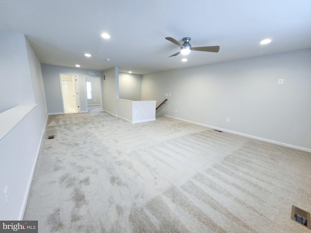 carpeted spare room with recessed lighting, visible vents, baseboards, and ceiling fan