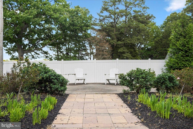 view of patio featuring fence