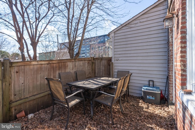 view of patio with outdoor dining area and a fenced backyard