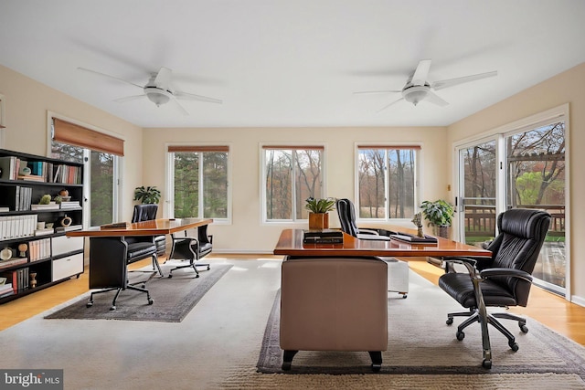 home office featuring light wood-style floors and ceiling fan