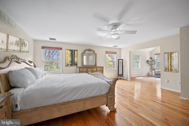 bedroom with ceiling fan, baseboards, visible vents, and light wood-style flooring