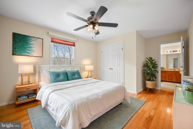 bedroom featuring a ceiling fan, baseboards, light wood-style floors, and a closet