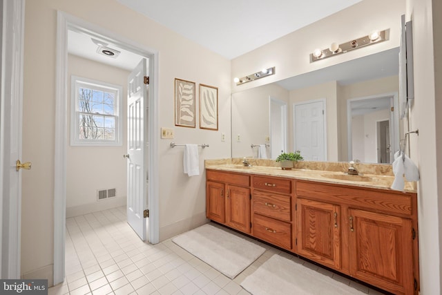 full bathroom featuring double vanity, visible vents, tile patterned floors, and a sink