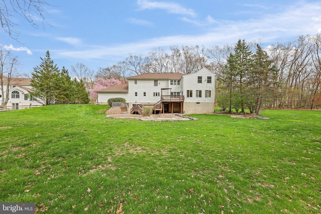back of house featuring a lawn, a patio, stairs, and a deck