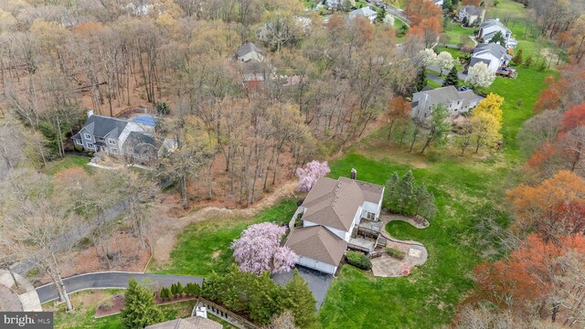 birds eye view of property with a forest view and a residential view