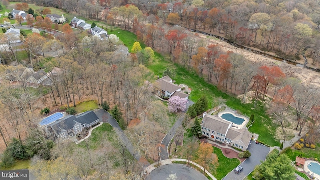 drone / aerial view featuring a wooded view