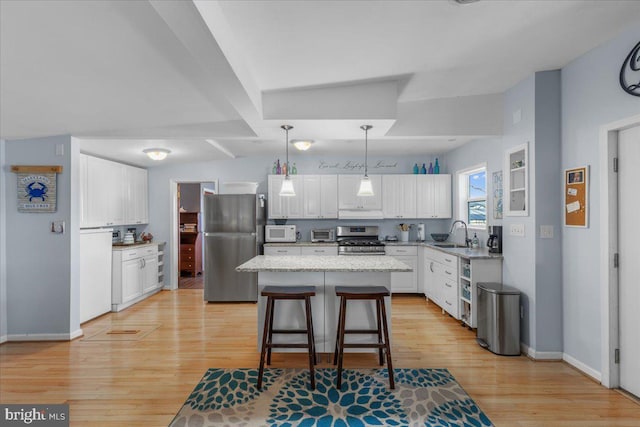 kitchen with light wood-style flooring, appliances with stainless steel finishes, and white cabinets