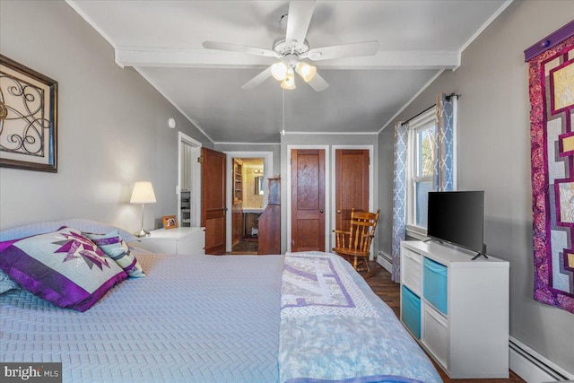 bedroom with wood finished floors, a baseboard heating unit, ceiling fan, and ornamental molding