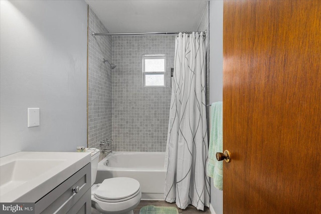 bathroom featuring toilet, vanity, and shower / bathtub combination with curtain