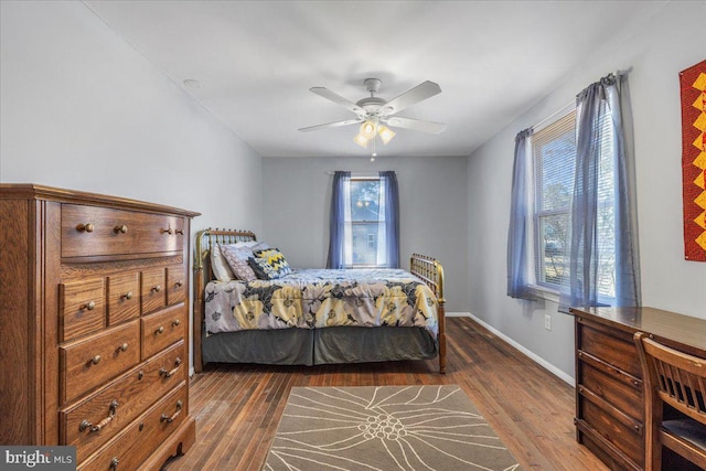 bedroom with baseboards, dark wood-style flooring, and ceiling fan