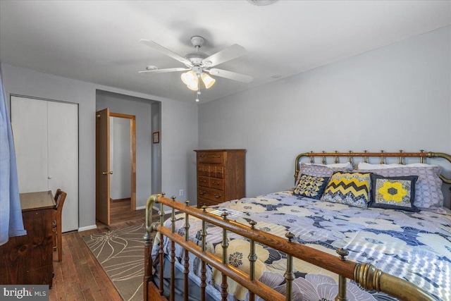 bedroom with ceiling fan, a closet, and wood finished floors