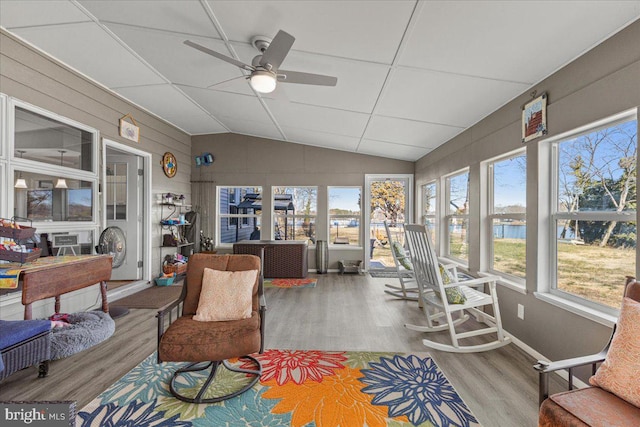 sunroom / solarium featuring lofted ceiling and a ceiling fan