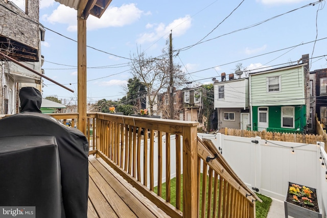 deck with fence and a residential view