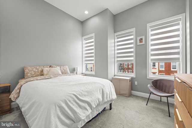 bedroom with recessed lighting, light colored carpet, and baseboards