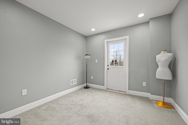 spare room featuring recessed lighting, carpet flooring, baseboards, and visible vents