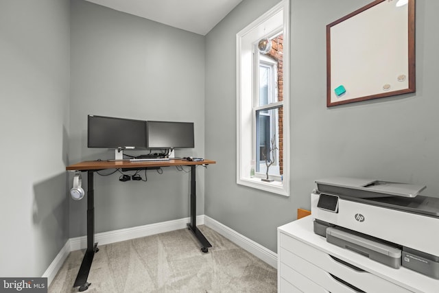 home office featuring baseboards and light colored carpet