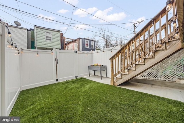 view of yard with a patio area, a gate, and a fenced backyard