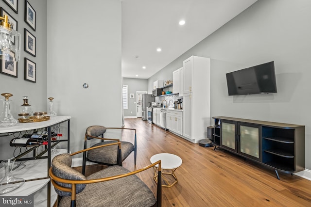 living room with recessed lighting, baseboards, and hardwood / wood-style floors