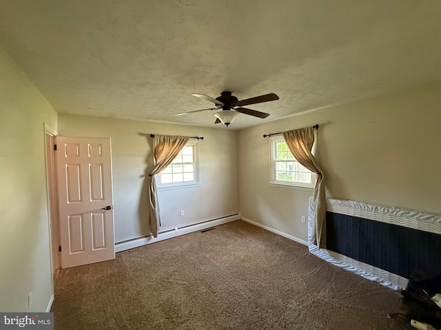 carpeted empty room with baseboards, a ceiling fan, and baseboard heating