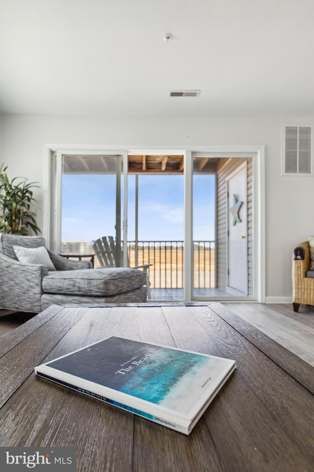 interior space featuring wood finished floors, a healthy amount of sunlight, and visible vents