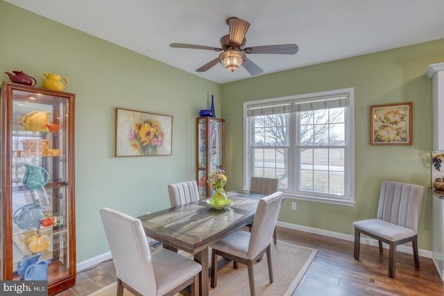 dining room with ceiling fan, baseboards, and light wood-style flooring