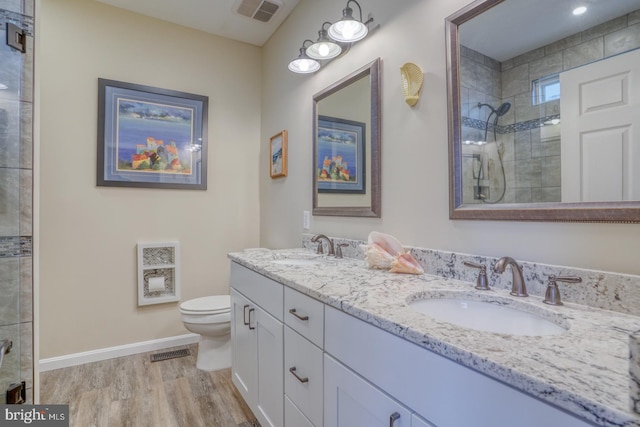 bathroom featuring a sink, visible vents, and a tile shower