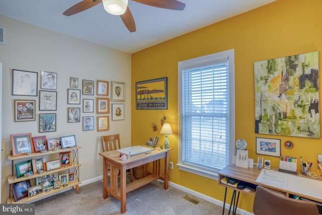 office featuring a wealth of natural light, visible vents, carpet, and ceiling fan