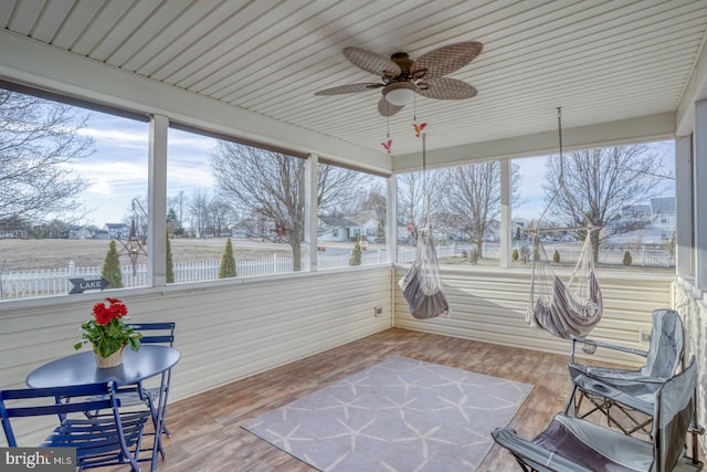 sunroom / solarium featuring a ceiling fan