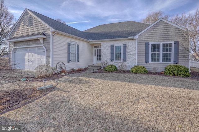 single story home with stone siding, an attached garage, a front yard, and roof with shingles