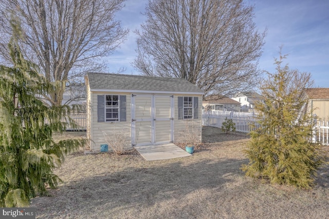 view of shed with fence