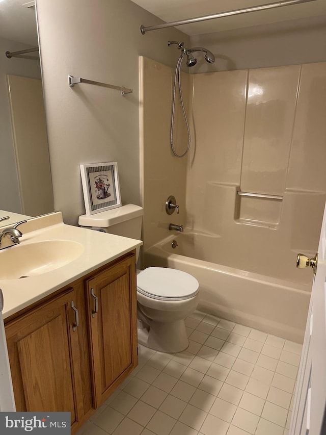 bathroom featuring vanity, tile patterned floors, toilet, and bathing tub / shower combination