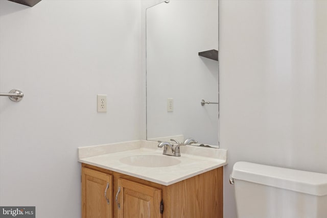 bathroom featuring toilet and vanity