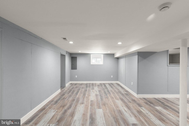 below grade area with recessed lighting, light wood-style flooring, visible vents, and baseboards