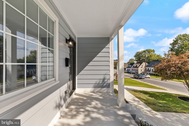 view of patio with a residential view and a porch