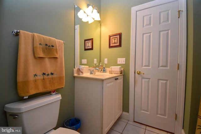 half bathroom featuring tile patterned flooring, toilet, and vanity